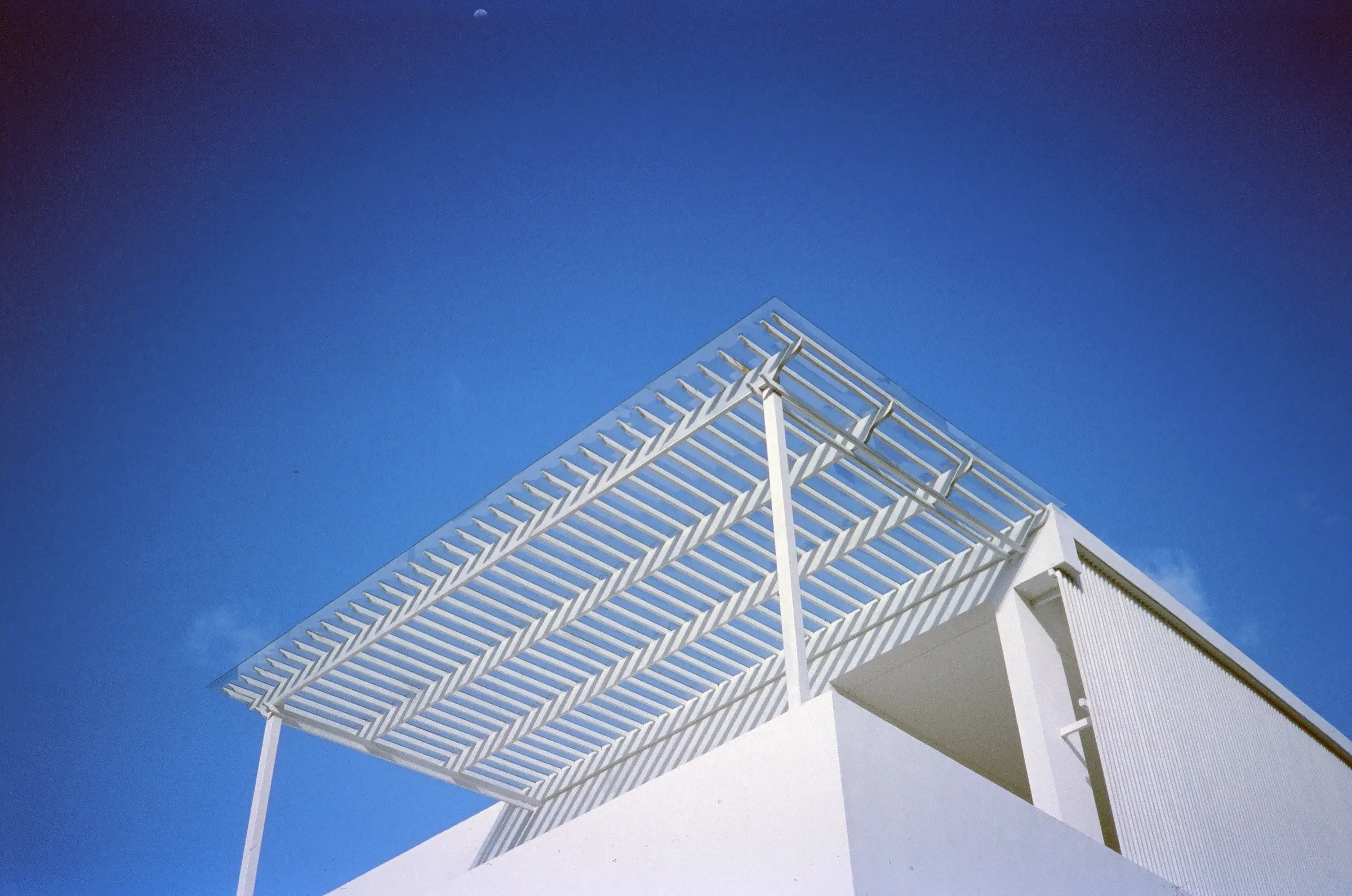 White architectural lattice against deep blue sky